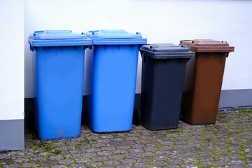 row of plastic garbage container, in Germany, garbage collection in designated place, environmental concept, different types of garbage into different bins, environmental protection, waste recycling