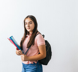 Young student with colorful folders is looking at the camera.