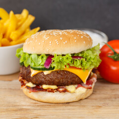 Hamburger Cheeseburger meal fastfood fast food with French Fries on a wooden board square