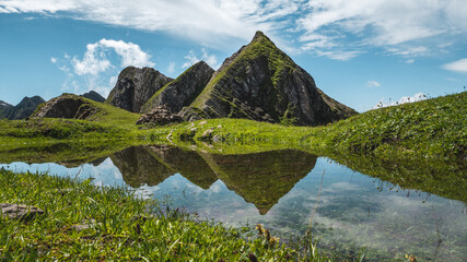Aravis moutains summit reflection, hiking in summer, french alps, near la Clusaz
