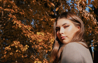 Cute young woman at autumn park.