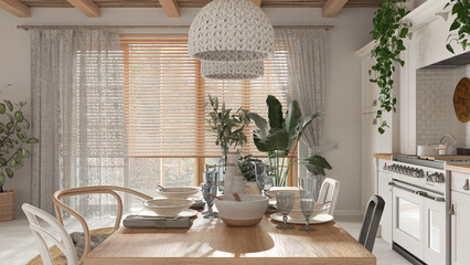 Wooden country dining table setting in white and beige tones. Kitchen, pendant lamps and window. Scandinavian boho interior design