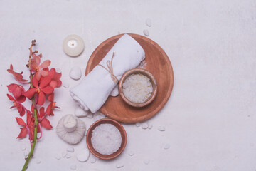 Composition of spa settings with red orchid on white background