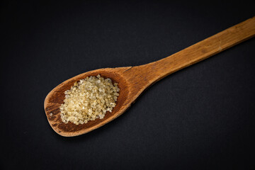 wooden spoon with salt and spices on a dark background
