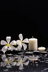 Poster Still life of with Plumeria, frangipani with candle  zen black stones on wet background © Mee Ting