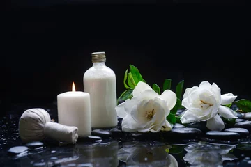 Fotobehang Still life of with  gardenia with green leaves, and spa ball ,candle  zen black stones on wet background  © Mee Ting