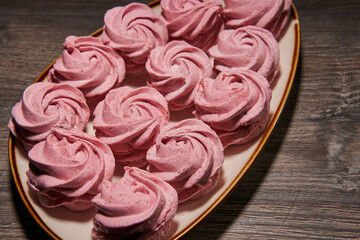 beautiful pink marshmallows on a plate close-up. marshmallow with cranberries
