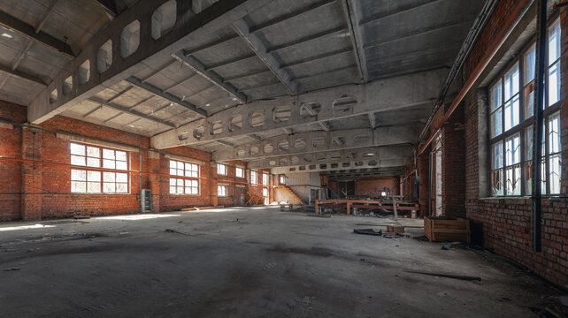 Abandoned industrial building with concrete trusses brick walls