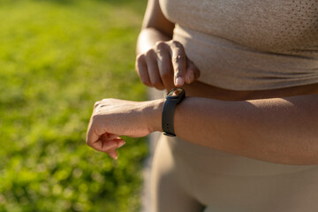 Close up African American woman using smart watch during the training