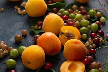 Close up of fresh apricots and fruits on dark surface food