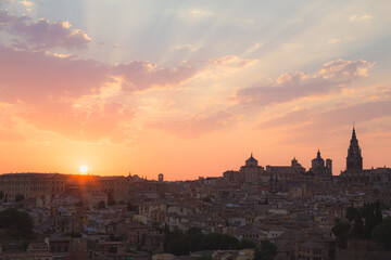 Silhouette of the skyline view of historic, medieval town Toledo, Spain during a colourful, vibrant sunset or sunrise.