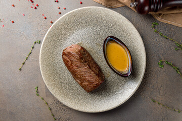 roast beef Steak with honey mustard sauce on plate on brown table