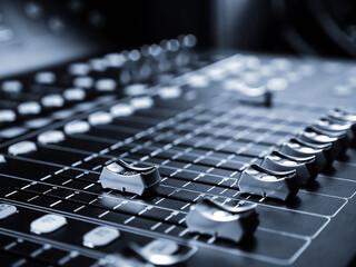 Sound audio mixer at record studio.  Blue tone