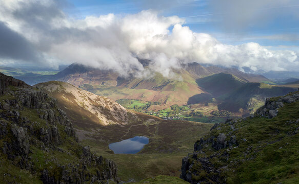 The cloud covered summit of Grasmoor with Bleaberry Tarm below the summit of Red Pike and High Stile in the autumn in the Lake District, UK.
