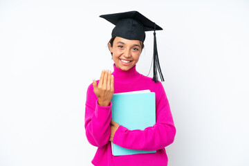 Young student hispanic woman holding a books isolated on white background inviting to come with hand. Happy that you came