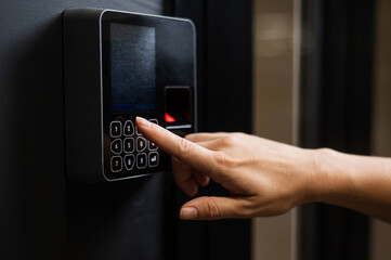 The woman enters the code and opens the door. Modern keyless entry lock. 