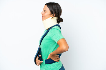 Young hispanic woman wearing a neck brace and sling isolated on white background suffering from backache for having made an effort