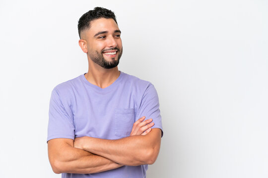 Young Arab handsome man isolated on white background with arms crossed and happy