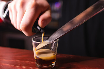 Bartender prepares B52 Shot. Making cocktails at a party, pouring liquor