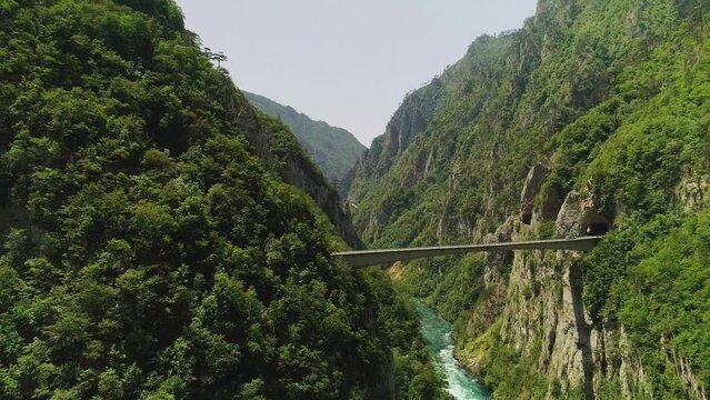 Aerial video. Shooting a beautiful deep canyon and bridge on a sunny summer day