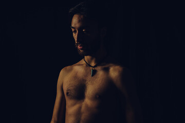 Fototapeta na wymiar young latin man slim and tanned shirtless, studio picture