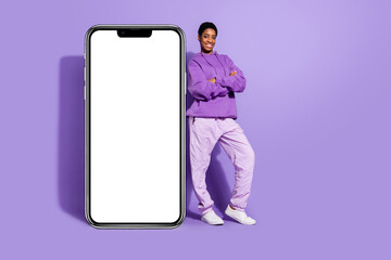 Photo of self-assured transgender person crossed hands placard blank space wear hoodie isolated purple color background