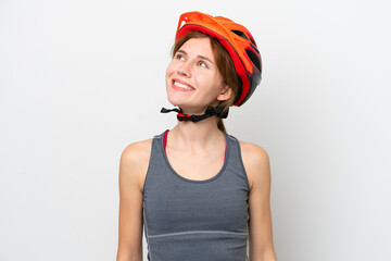 Young cyclist English woman isolated on white background thinking an idea while looking up