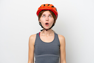 Young cyclist English woman isolated on white background looking up and with surprised expression