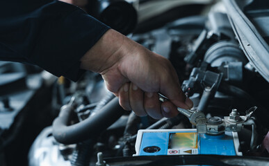 A Professional mechanic providing car repair and maintenance service in auto garage. Car service business concept.