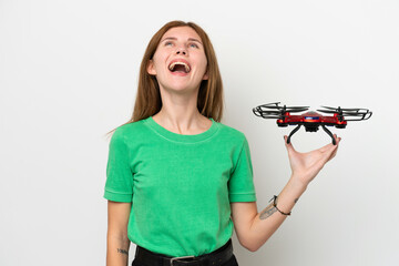 Young English woman holding a drone isolated on white background laughing
