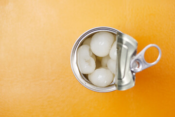 longans fruits in a tin container color background 