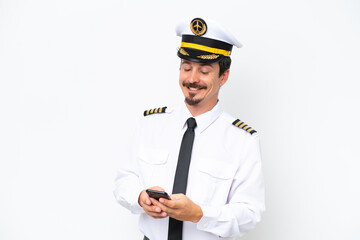 Airplane caucasian pilot isolated on white background sending a message with the mobile