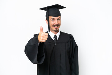 Young university graduate man isolated on white background with thumbs up because something good has happened