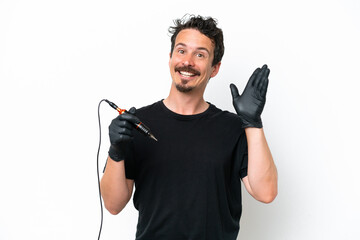 Tattoo artist man isolated on white background saluting with hand with happy expression