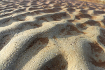 Wave-shaped sand is formed by the flow of river water