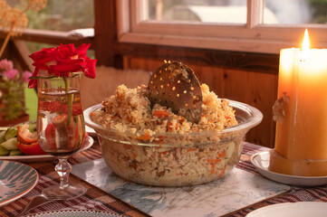dinner in the village - pilaf on the tables and candle
