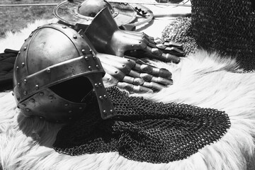 Knight helmet and gauntlets on fur. Middle ages armor still life background. Medieval festival...