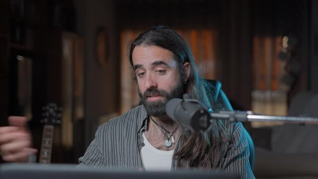 Handsome bearded vocal coach teaching online to his YouTube audience the different kind of voices that exist