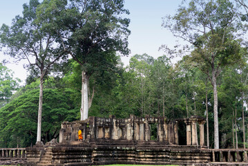 Buddhist monk visiting ruins in Angkor Wat