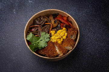Japanese ramen soup with noodles, meat in a cardboard disposable plate
