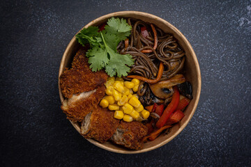 Japanese ramen soup with noodles, meat in a cardboard disposable plate
