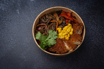 Japanese ramen soup with noodles, meat in a cardboard disposable plate
