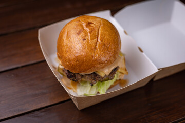 mouth-watering burger with cutlet, cheese and vegetables

