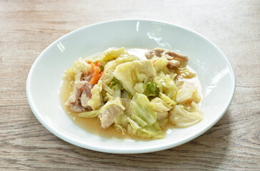 stir fried slice cabbage and pork with fish sauce on plate 