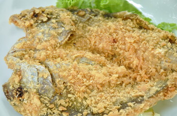 deep fried black-banded trevally fish with flake bread on plate dipping spicy and soy mango sauce 