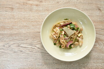 Thai spicy chop pork and slice liver with skin salad on plate