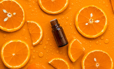 Essential oil of orange on a yellow background. Selective focus.