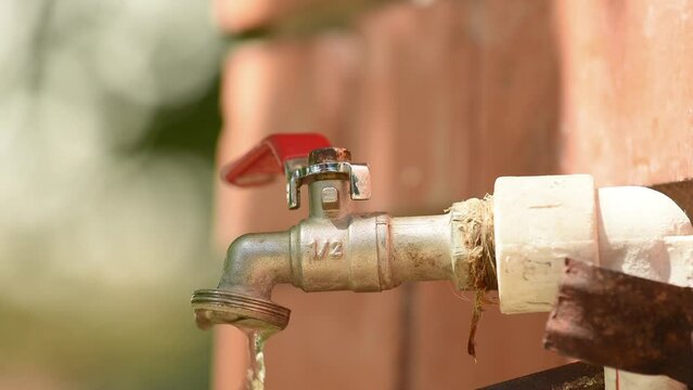 Back yard garden spigot faucet with dripping water