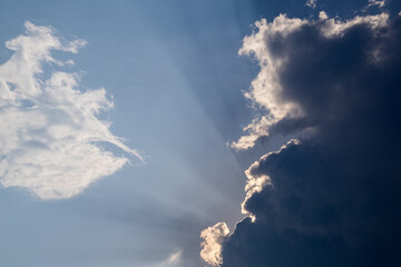 Sun rays emerging from behind the clouds.