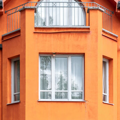Part of red-orange colorful building, exterior detail